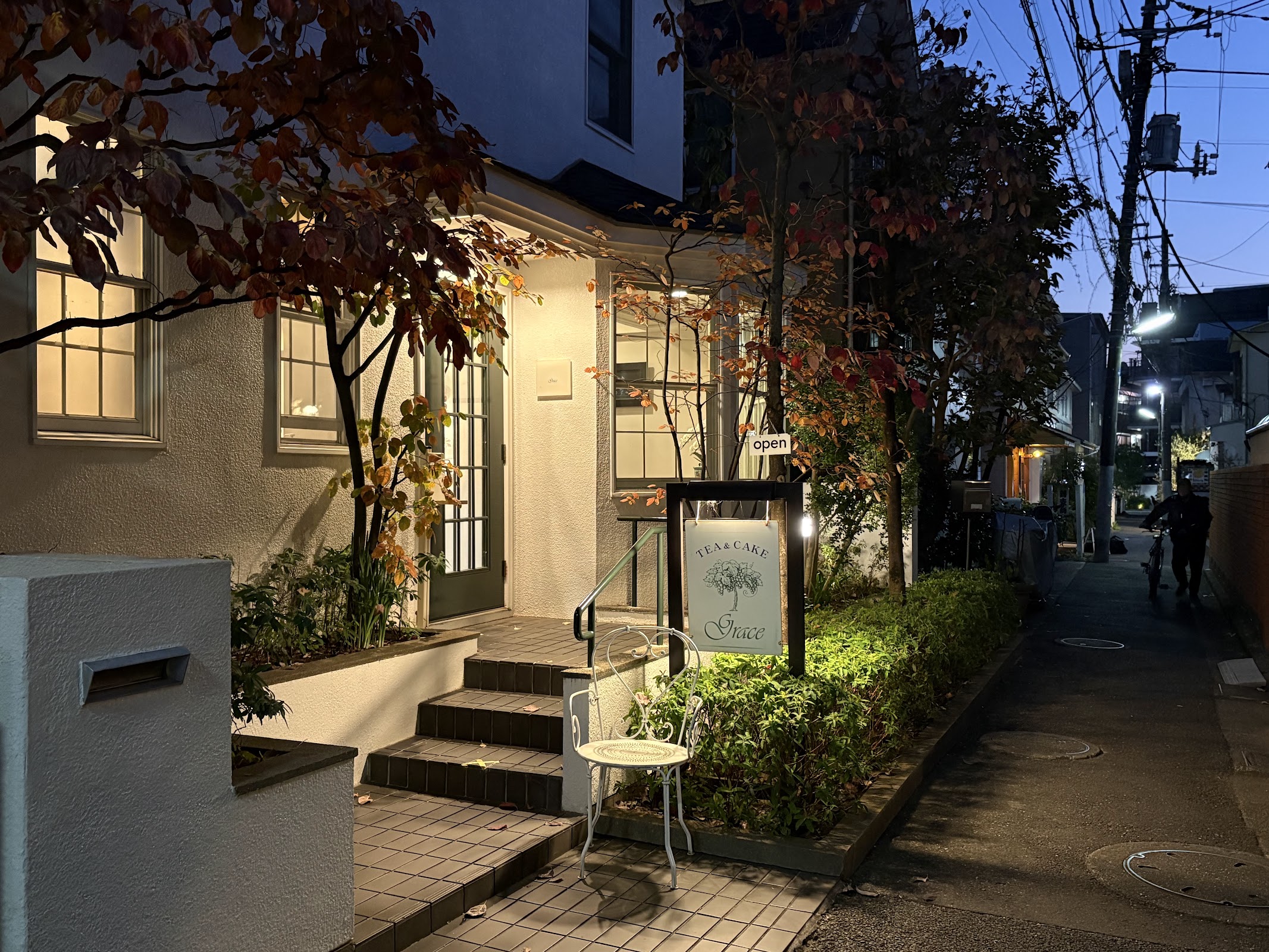 西荻窪南口、住宅街の通りに面した一軒家。秋の紅葉と OPEN の立て看板、軒先の白い椅子。